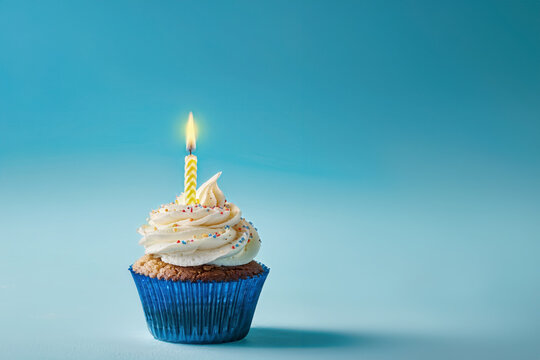 Cupcake with candle  on blue background,birthday cake.