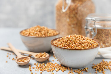 Green buckwheat in a bowl on a wooden kitchen table.Superfood.Raw buckwheat porridge.Healthy vegan food concept, eco products, diet. Copy space.Organic food.weight loss and proper nutrition.