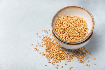 Green buckwheat in a bowl on a wooden kitchen table.Superfood.Raw buckwheat porridge.Healthy vegan food concept, eco products, diet. Copy space.Organic food.weight loss and proper nutrition.