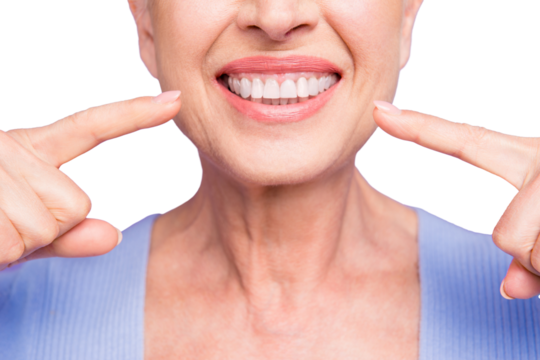 Concept of having strong healthy straight white perfect teeth at old age. Cropped portrait of beaming smile female pensioner pointing on her teeth, isolated over violet background