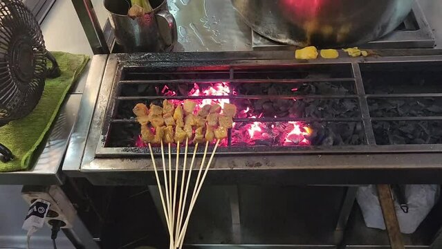 Sate Padang being grilled over hot coals, a delicious and savory Indonesian West Sumatran satay specialty
