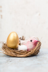 golden easter egg in bird nest and bird