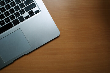 A business desk table with a laptop. Wood background with copy space.