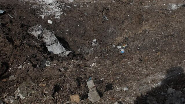 Shelling of civilians. Explosion crater and rocket debris after. War in Ukraine. A private house. Military aggression.