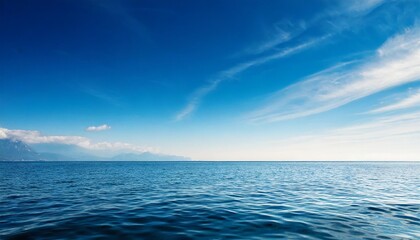 clean blue sky above a blue surface of the sea