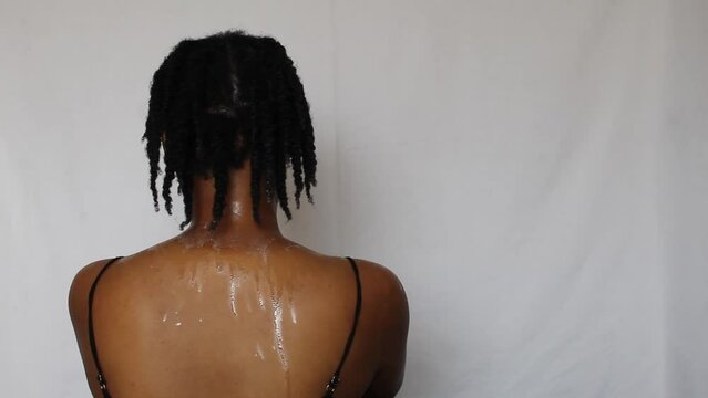 Black woman with twists on her natural 4c hair on a white background