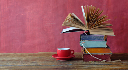 Stack of books with open book and cup of espresso coffee, reading, learning, knowledge is...