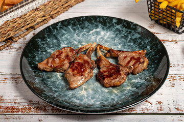 Freshly grilled lamb chops. Slices of cooked lamb chops on wood background. high quality photo
