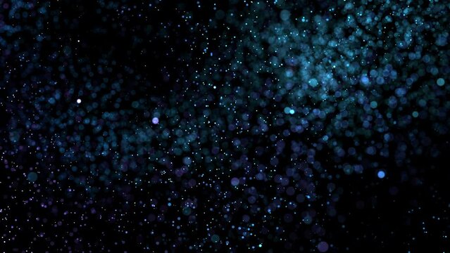 Dynamic blue shimmering particles randomly float in dark space. Abstract concept of holiday celebration and festive mood or science and technology. 4K looped animation of bright 3D flying sparks.