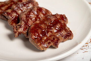 Freshly grilled beef tenderloin slices. Slices of cooked tenderloin on wood background. high quality photo. Close up