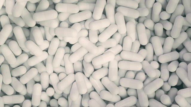 Manufacturing of medications and pharmaceuticals, numerous capsules. Close-up of medicinal tablets spinning. Medications substances. The pharmaceutical sector. Concept of healthcare.