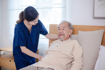 Obraz premium Health insurance service, Young Asian caregiver nurse examine senior man or woman patient at home. Attractive specialist career female support give advise and therapy consult to older elderly mature