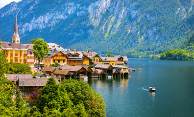 Chapel in Hallstatt old town famous landmark Austria on lake Hallstattersee among Austrian Alps mountains with green forests. Hallstatter panoramic view. Travel destination Europe.