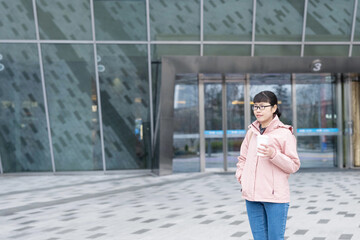 Middle-aged woman carrying coffee to work in the morning © Lili.Q