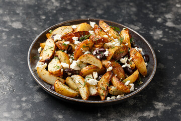Greek fried potatoes with feta cheese, kalamata olives, parsley and dill