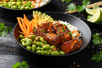 Firecracker salmon poke bowl with edamame, avocado carrot and rice