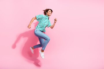 Fototapeta na wymiar Full length profile photo of cheerful lovely person jump rush empty space isolated on pink color background