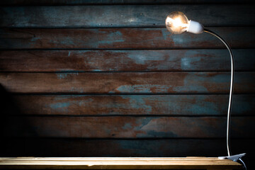 abstract Vintage tone of Old wooden backdrop with Tungsten filament lamps on wooden floor.