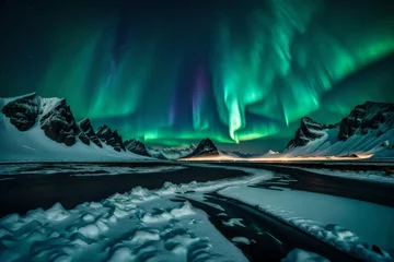 Poster Amazing view of green aurora borealis shining in night sky over snowy mountain ridge with black sand stockness beach and vestrahorn mountain. © MSohail