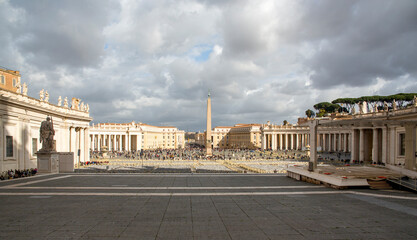 View of St. Peter's square located in the Vatican city. This state is an enclave within the city of Rome, Italy. The obelisk in the center is known as 