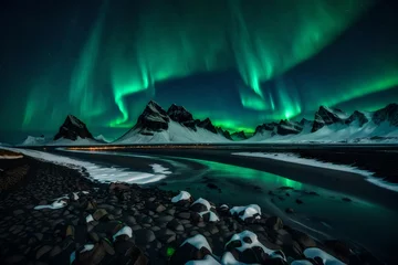 Photo sur Plexiglas Aurores boréales Amazing view of green aurora borealis shining in night sky over snowy mountain ridge with black sand stockness beach and vestrahorn mountain.