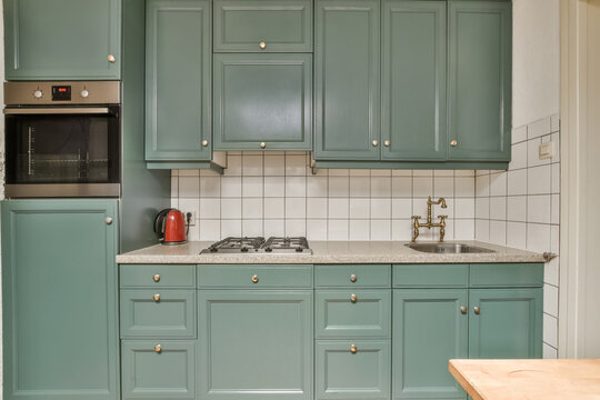 Modern kitchen with green cabinets and stainless appliances