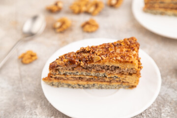 Walnut and hazelnut cake with caramel on brown concrete. side view, selective focus
