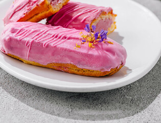 Eclairs with pink glaze close up