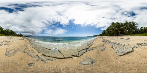 Fototapeta na wymiar Waves crashing over the beach in Carabao Island. Blue sky and clouds. Romblon, Philippines. VR 360.