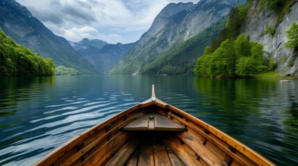 Obraz premium Enjoy in river under mountain, view from the bow of a small wooden boat to the calm lake and mountain landscape