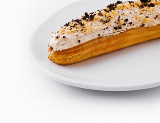 Eclair with cream and chocolate on plate