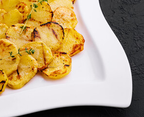fried potatoes on a white plate