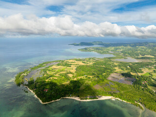 Aerial view of tropical island with white beach and turquoise sea water. Looc, Tablas Island....