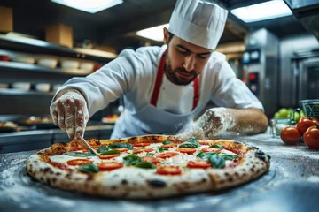 Tuinposter Pizza chef finishing the preparing of in professional pizzeria restaurant kitchen. © jakapong