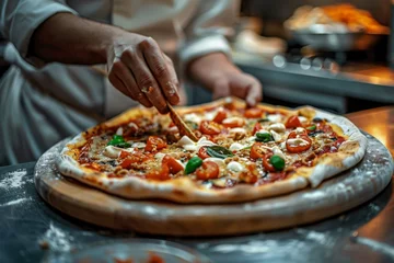 Foto op Aluminium Pizza chef finishing the preparing of in professional pizzeria restaurant kitchen. © jakapong