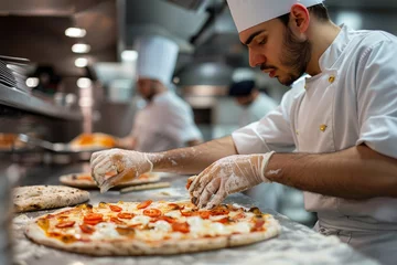 Küchenrückwand glas motiv Pizza chef finishing the preparing of in professional pizzeria restaurant kitchen. © jakapong