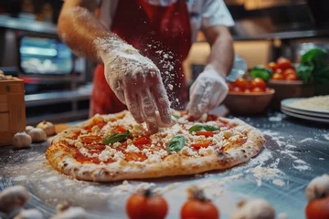  Pizza chef finishing the preparing of in professional pizzeria restaurant kitchen. © jakapong