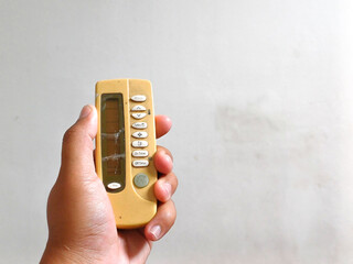 Close up of hand hold vintage air conditioner remote controller, AC used for cooling house...