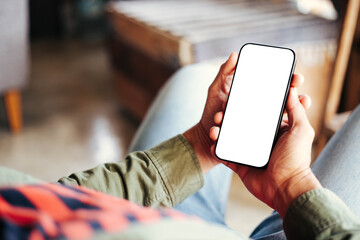 cell phone blank white screen mockup.hand holding texting using mobile on desk at office.background...