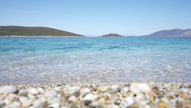 Crystal clear turquoise waters in the beach of Megali Ammos, in Evia (Euboea) island, Greece, Europe.