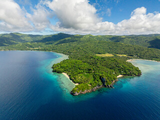 Blue sea and tropical island with green forest. Blue sky and clouds. Romblon Island in Romblon. Philippines.