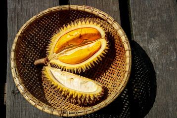 Opened Yellow Durian Fruit in a Rattan Basket on an Old Wooden Table in Sarawak Borneo - 750595133