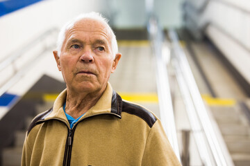 Senior man walking down the stairs to subway station