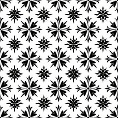 A black and white floral patterned background with a white flower in the center