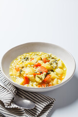 Israeli soup with ptitim, vegetables and spinach.