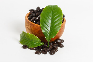 Coffee beans roasted dark with leaf on white background