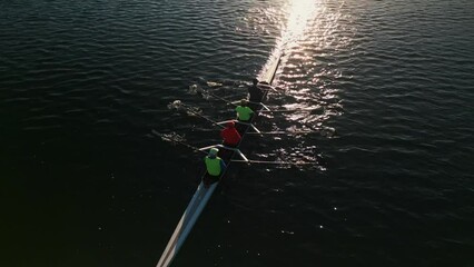 Rowers in eight-oar rowing boats tranquil ocean early morning training in Halifax Harbor with a beautiful sunrise.Canada.Four young athletes row on a sunny morning preparing for a rowing competition. - Powered by Adobe