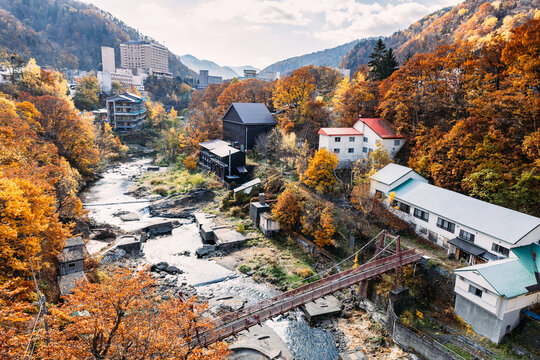 Sapporo, Hokkaido, Japan - November 2023 : Autumn scenery of Jozankei Onsen Resort, a famous hot spring destination with the hotels and traditional Ryokan surrounded by fall colors.