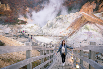 Beautiful girl with view during Authum and Steam rising in the Hell valley or Noboribetsu...
