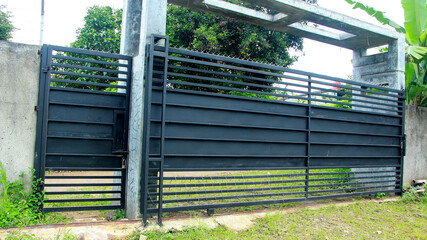 Gate fence, with barbed wire at the bottom and top